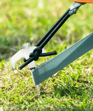 Set of 15 screw-in tent stakes with metal design, perfect for securing tents and outdoor structures, packed in a convenient plastic box